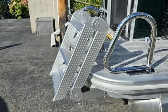 Slide: The Image of 2026 Bennington 22 SF boat ladder and railing detail in a marina setting. - 18