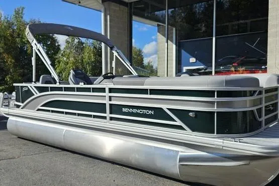 Slide: The Image of 2026 Bennington 22 SF pontoon boat parked outside a showroom. - 4