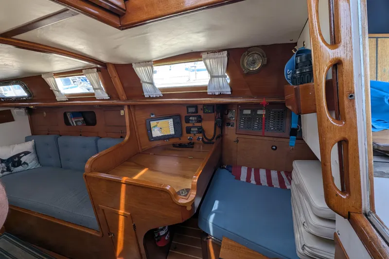 Slide: The Image of Interior of 1984 Ohlson 38 sailboat with navigation equipment and cozy seating area. - 14