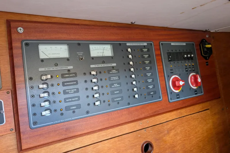 Slide: The Image of Electrical control panel on a 1984 Ohlson 38 boat, featuring switches and gauges. - 18