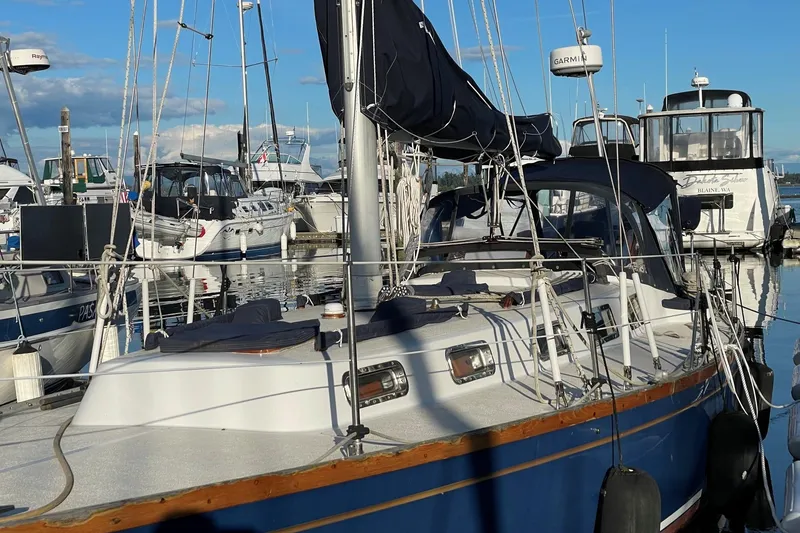 Slide: The Image of Sailboat Ohlson 38, 1984 model, docked in a marina with other boats. - 2
