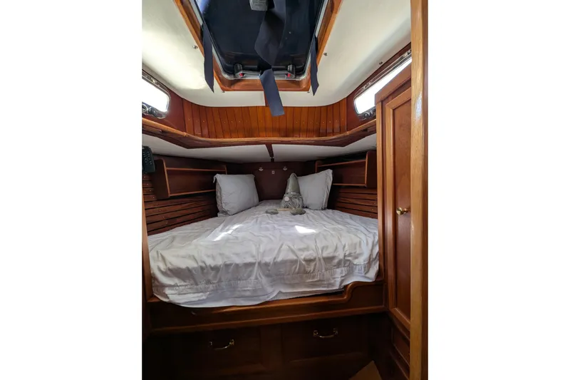 Slide: The Image of Cozy cabin interior of 1984 Ohlson 38 sailboat with wooden paneling and bedding. - 25