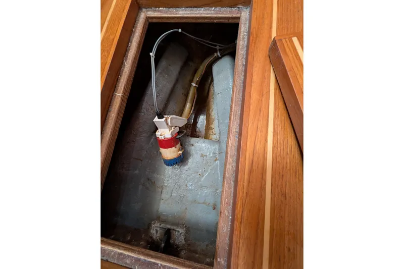 Slide: The Image of Bilge compartment of 1984 Ohlson 38 sailboat with pump and wiring. - 26