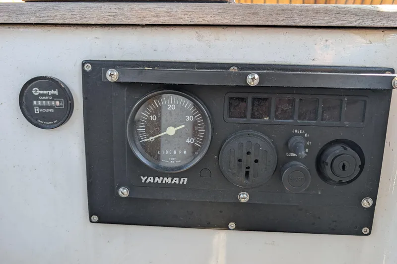 Slide: The Image of Control panel of a 1984 Ohlson 38 sailboat featuring Yanmar engine gauges. - 34