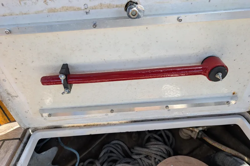 Slide: The Image of Red lever inside Ohlson 38 sailboat hatch, 1984 model, with ropes and equipment. - 39