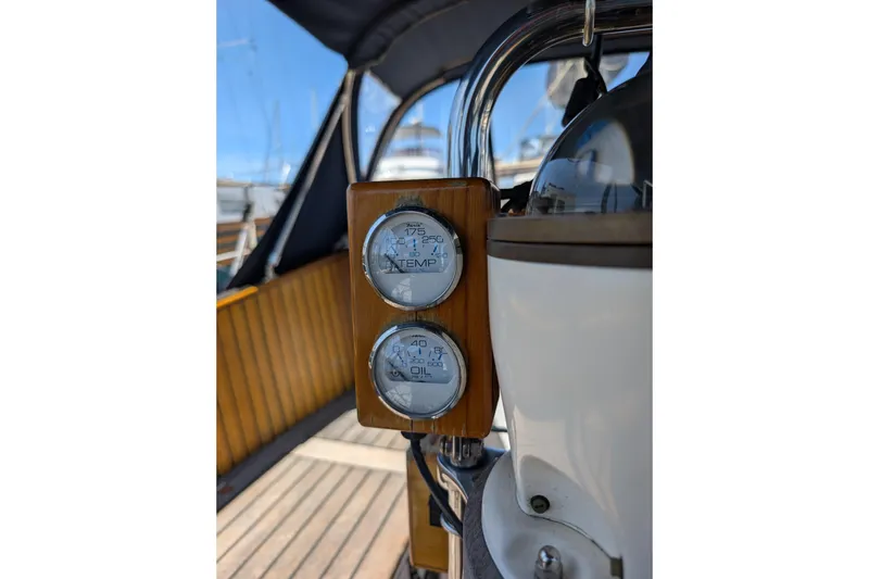 Slide: The Image of Gauges on 1984 Ohlson 38 sailboat dashboard, displaying temperature and oil levels. - 40