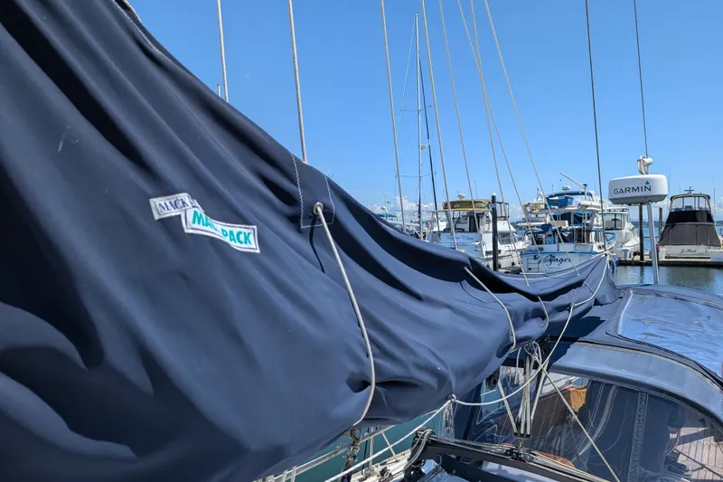 Slide: The Image of Sailboat with Mack Pack cover in marina, Ohlson 38, 1984 model, clear blue sky. - 41