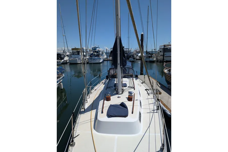 Slide: The Image of Sailboat docked in marina, Ohlson 38 model, 1984, clear sky, calm water. - 43