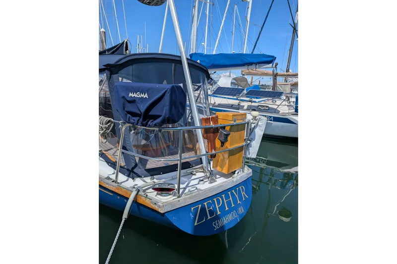 Slide: The Image of Sailboat "Zephyr" docked, Ohlson 38 model, 1984, with blue cover and marina background. - 46