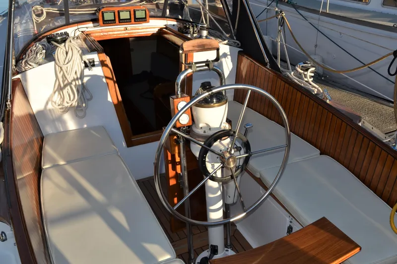 Slide: The Image of Cockpit of 1984 Ohlson 38 sailboat with wooden accents and steering wheel. - 5