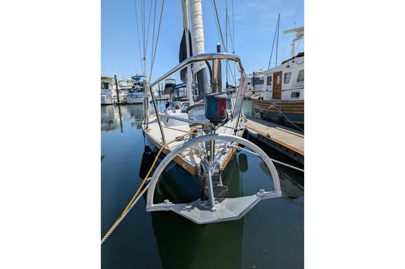 Slide: The Image of 1984 Ohlson 38 sailboat docked in a marina, featuring a prominent anchor. - 50