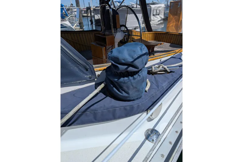Slide: The Image of 1984 Ohlson 38 sailboat deck with ropes and covered winch. - 51