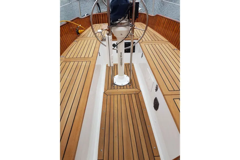 Slide: The Image of Cockpit of 1984 Ohlson 38 sailboat with wooden deck and steering wheel. - 6