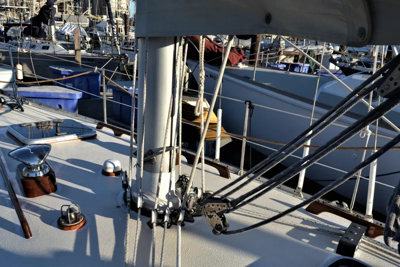 Slide: The Image of Deck of 1984 Ohlson 38 sailboat with rigging and marina background. - 7
