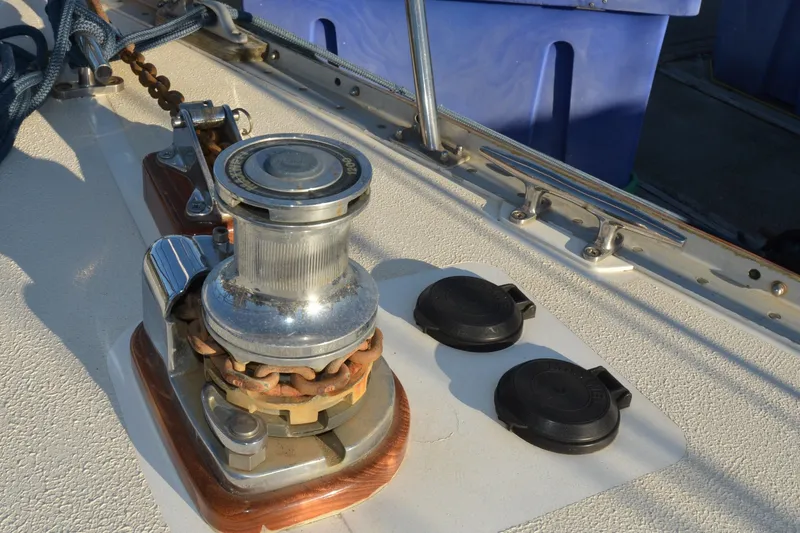 Slide: The Image of Deck equipment on a 1984 Ohlson 38 sailboat, featuring a winch and cleats. - 8