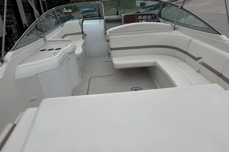Slide: The Image of 2002 Formula 330 Sun Sport boat interior with white seating and dashboard. - 11