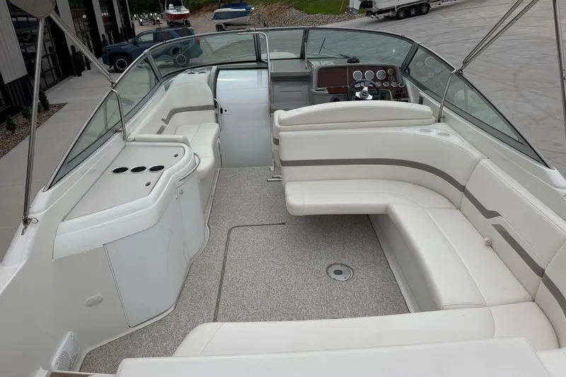 Slide: The Image of 2002 Formula 330 Sun Sport boat interior with white seating and dashboard. - 12