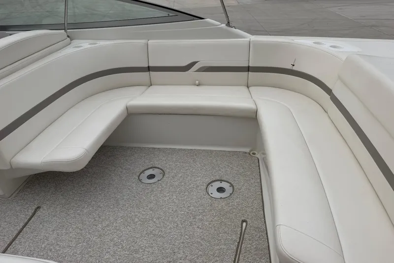 Slide: The Image of 2002 Formula 330 Sun Sport boat interior with white seating and carpeted floor. - 14