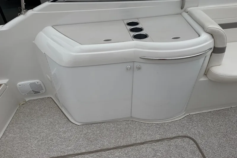 Slide: The Image of 2002 Formula 330 Sun Sport boat interior with storage cabinet and cup holders. - 15