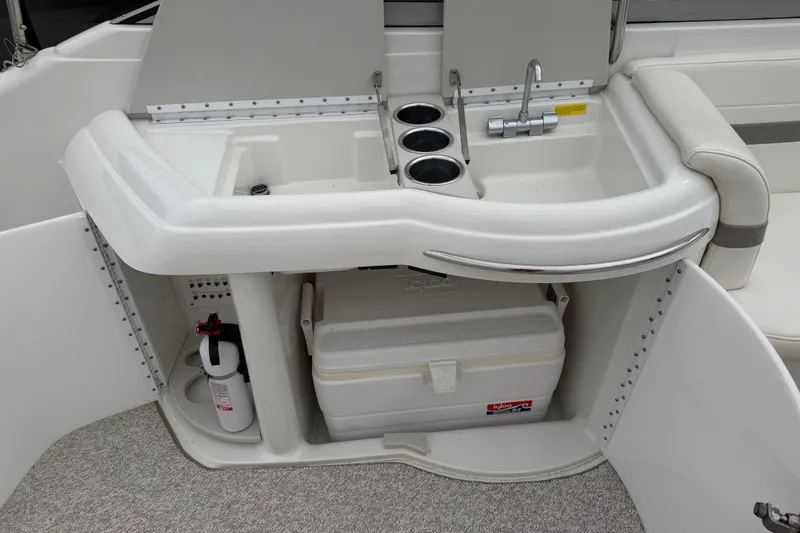 Slide: The Image of 2002 Formula 330 Sun Sport boat interior with sink, cup holders, and cooler storage. - 16
