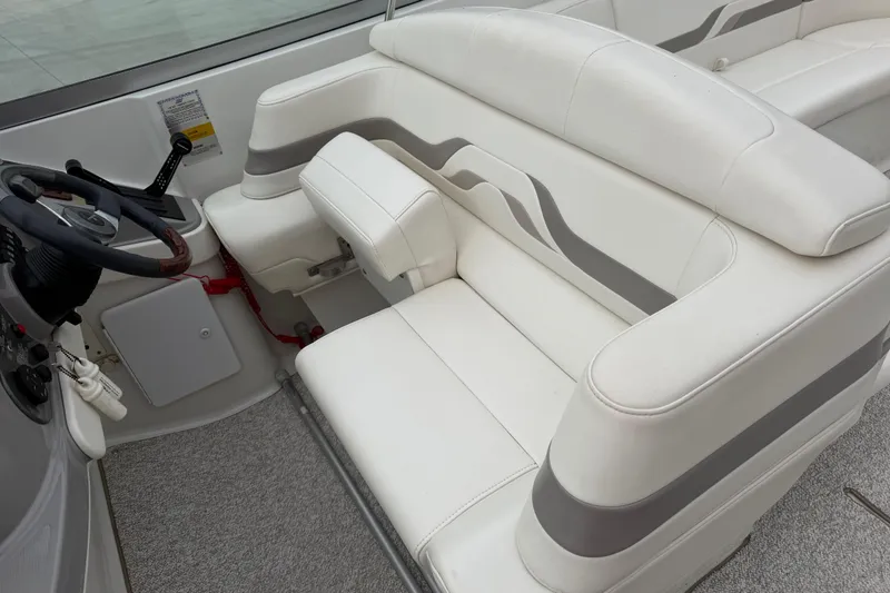 Slide: The Image of 2002 Formula 330 Sun Sport boat interior with white leather seating and steering wheel. - 18