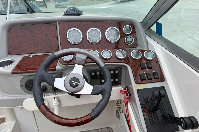 Slide: The Image of Steering console of a 2002 Formula 330 Sun Sport boat with gauges and controls. - 19