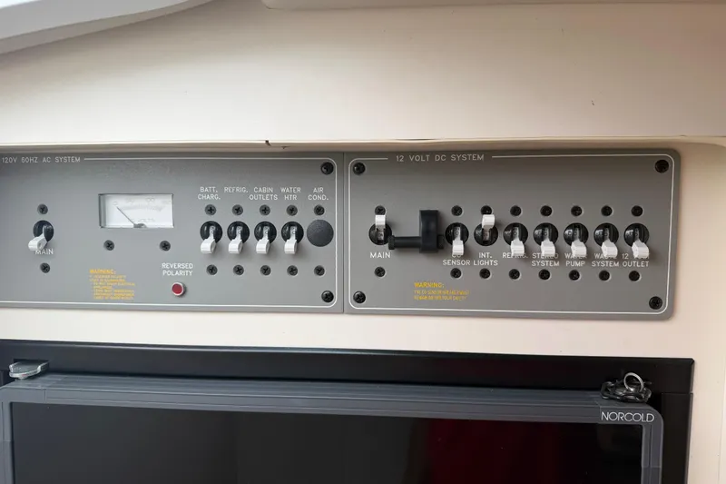Slide: The Image of Control panel of a 2002 Formula 330 Sun Sport boat, featuring AC and DC systems. - 24