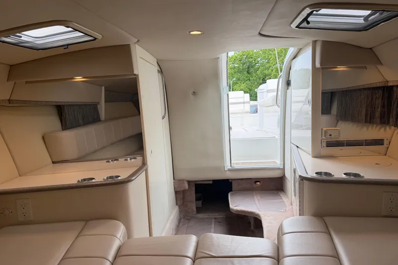 Slide: The Image of Interior of a 2002 Formula 330 Sun Sport boat, featuring beige seating and cup holders. - 25