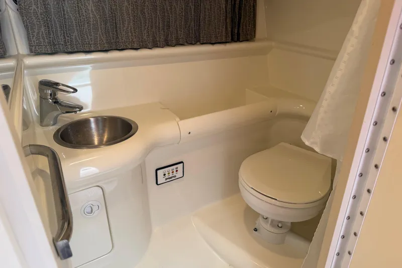 Slide: The Image of Bathroom interior of 2002 Formula 330 Sun Sport boat, featuring sink and toilet. - 26