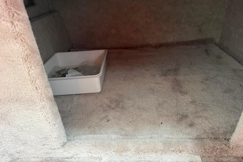 Slide: The Image of Interior of a 2002 Formula 330 Sun Sport boat with carpeted flooring and storage bin. - 29