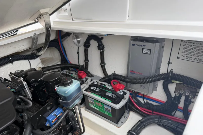 Slide: The Image of Engine compartment of a 2002 Formula 330 Sun Sport boat, featuring battery and wiring components. - 30
