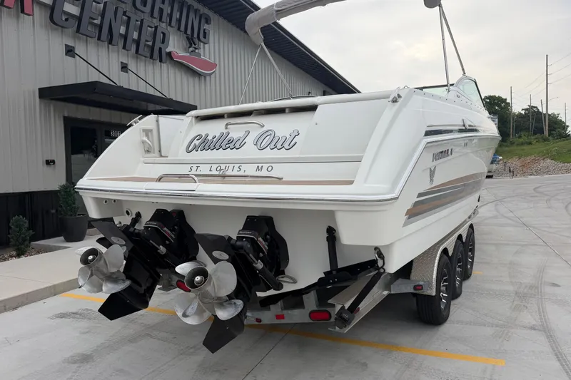 Slide: The Image of 2002 Formula 330 Sun Sport boat on trailer, labeled "Chilled Out," at a marina. - 4