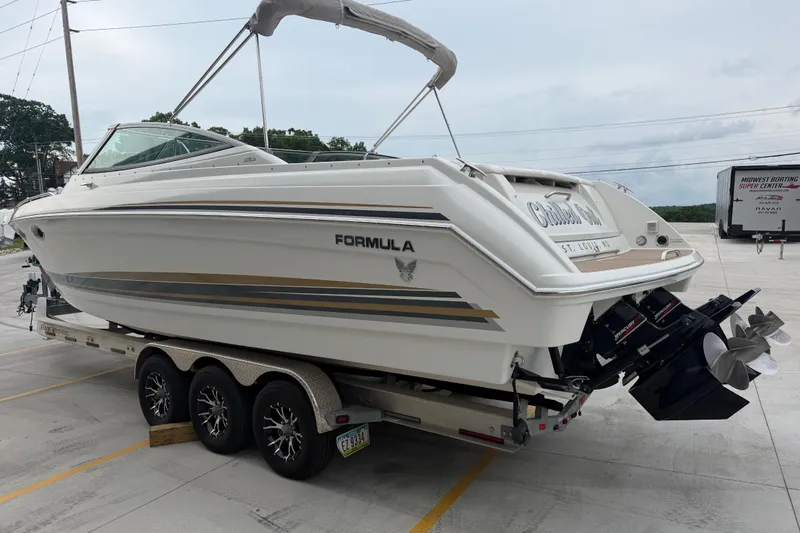 Slide: The Image of 2002 Formula 330 Sun Sport boat on trailer, parked outdoors. - 6