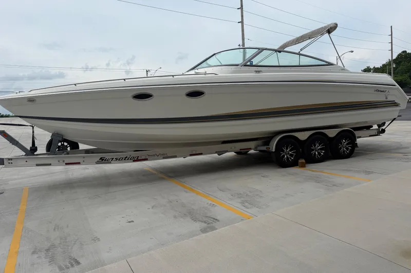 Slide: The Image of 2002 Formula 330 Sun Sport boat on trailer in parking lot. - 7
