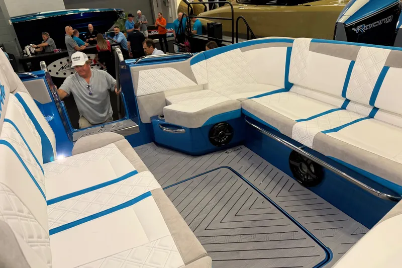 Slide: The Image of Luxurious interior of 2028 Nor-Tech 42 Eleven boat with white and blue seating. - 10