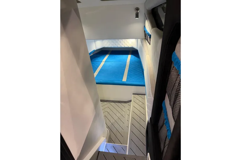 Slide: The Image of Nor-Tech 42 Eleven 2028 model showcased at a boat exhibition with vibrant blue design. - 18