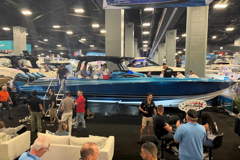 Slide: The Image of 2028 Nor-Tech 42 Eleven boat showcased at an indoor exhibition with attendees. - 5