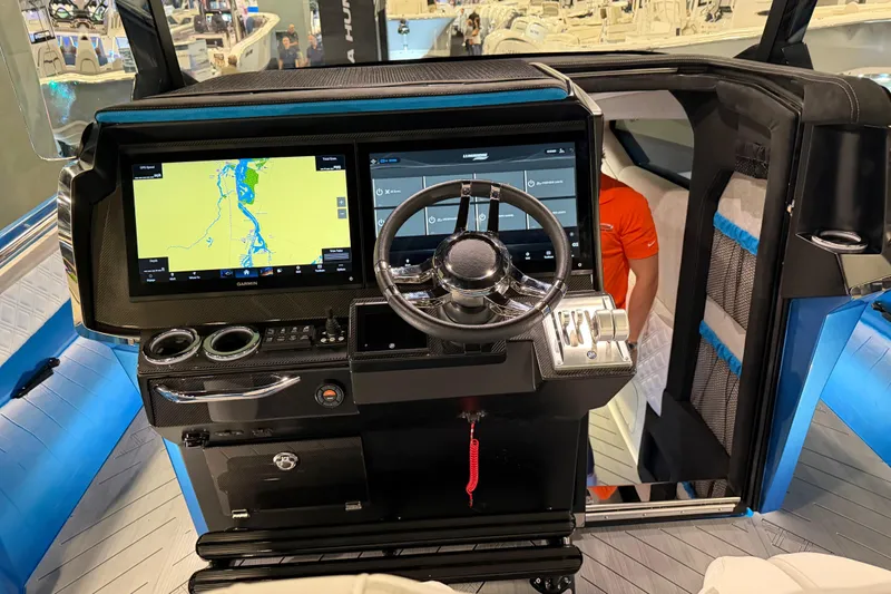 Slide: The Image of Cockpit of 2028 Nor-Tech 42 Eleven boat with advanced navigation system and steering wheel. - 6