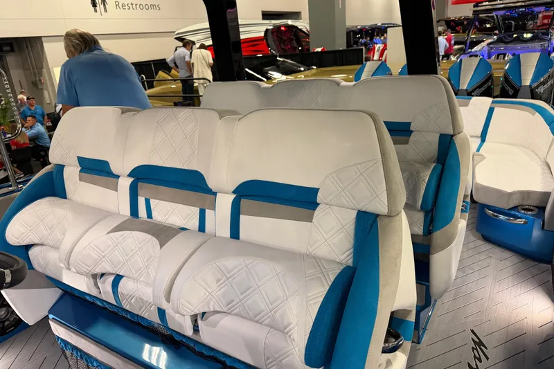 Slide: The Image of Luxurious seating inside a 2028 Nor-Tech 42 Eleven boat, featuring white and blue upholstery. - 7