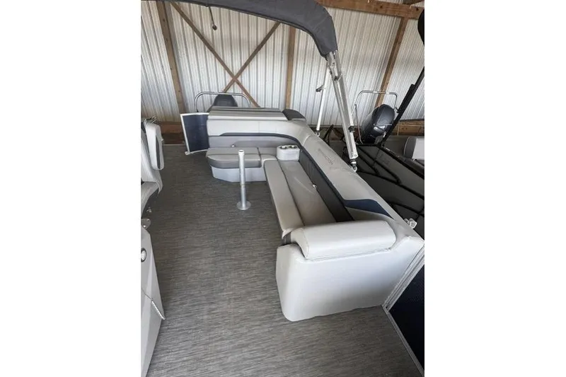 Slide: The Image of 2022 Bennington 22 SLX pontoon boat interior with gray seating and canopy. - 8
