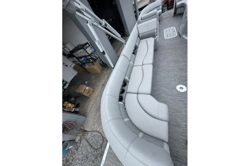 Slide: The Image of 2021 Bennington 24 LRSC pontoon boat with spacious gray seating and modern design. - 10