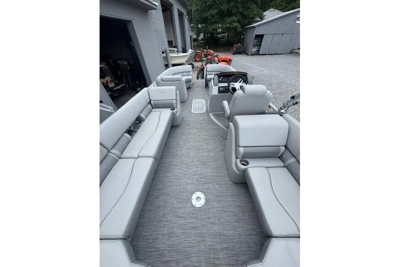 Slide: The Image of 2021 Bennington 24 LRSC pontoon boat interior with gray seating and steering console. - 11