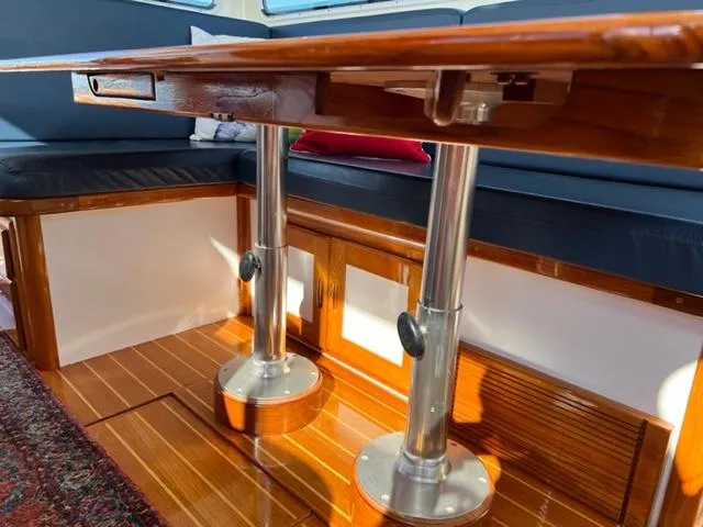 Slide: The Image of Interior of 2000 Duffy 35 Hardtop Cruiser with wooden table and seating area. - 10