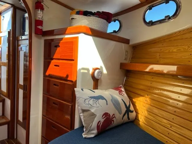 Slide: The Image of Interior of a 2000 Duffy 35 Hardtop Cruiser with wooden furniture and cushions. - 11