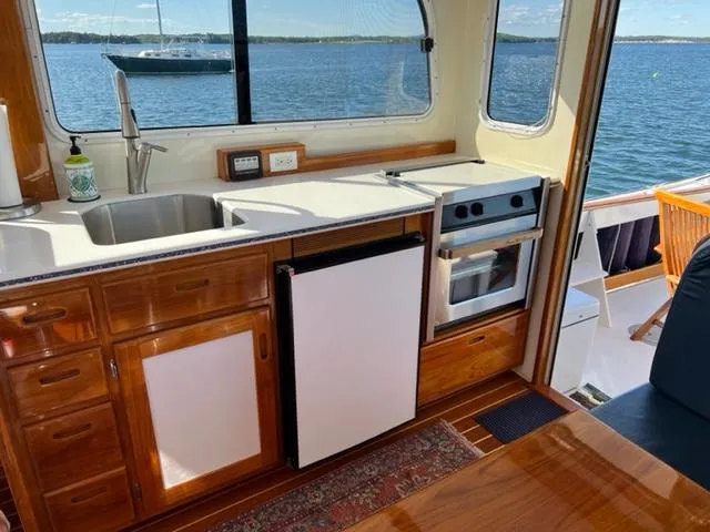 Slide: The Image of Interior of Duffy 35 Hardtop Cruiser with kitchen and sea view. - 12