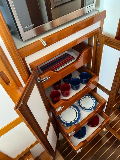 Slide: The Image of Kitchen cabinet in 2000 Duffy 35 Hardtop Cruiser with dishes. - 15