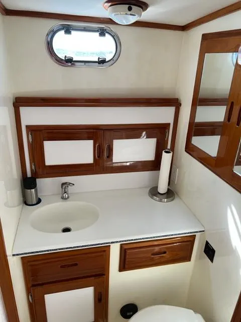 Slide: The Image of Interior of 2000 Duffy 35 Hardtop Cruiser with sink and wooden cabinets. - 21