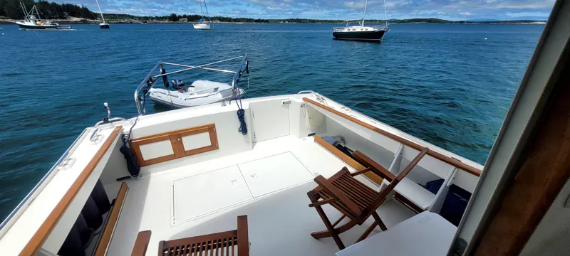 Slide: The Image of Deck of a 2000 Duffy 35 Hardtop Cruiser on calm waters. - 31