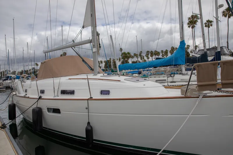 Slide: The Image of 1999 Beneteau Oceanis 36 CC sailboat docked at marina with cloudy sky. - 1