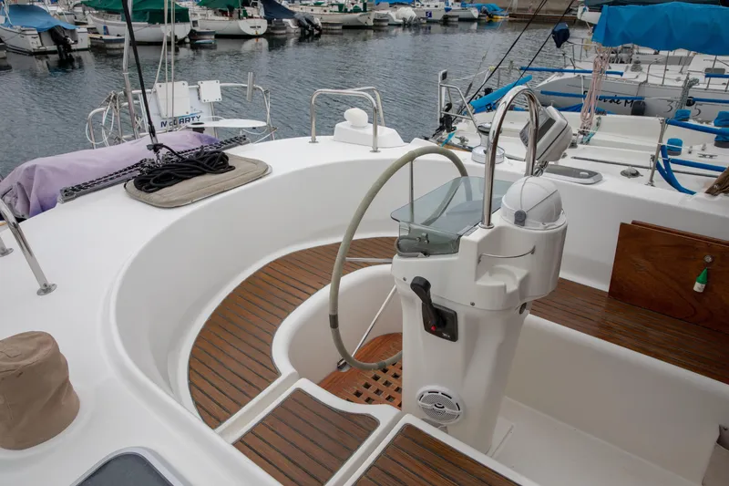 Slide: The Image of Cockpit of 1999 Beneteau Oceanis 36 CC sailboat with wooden flooring and steering wheel. - 10